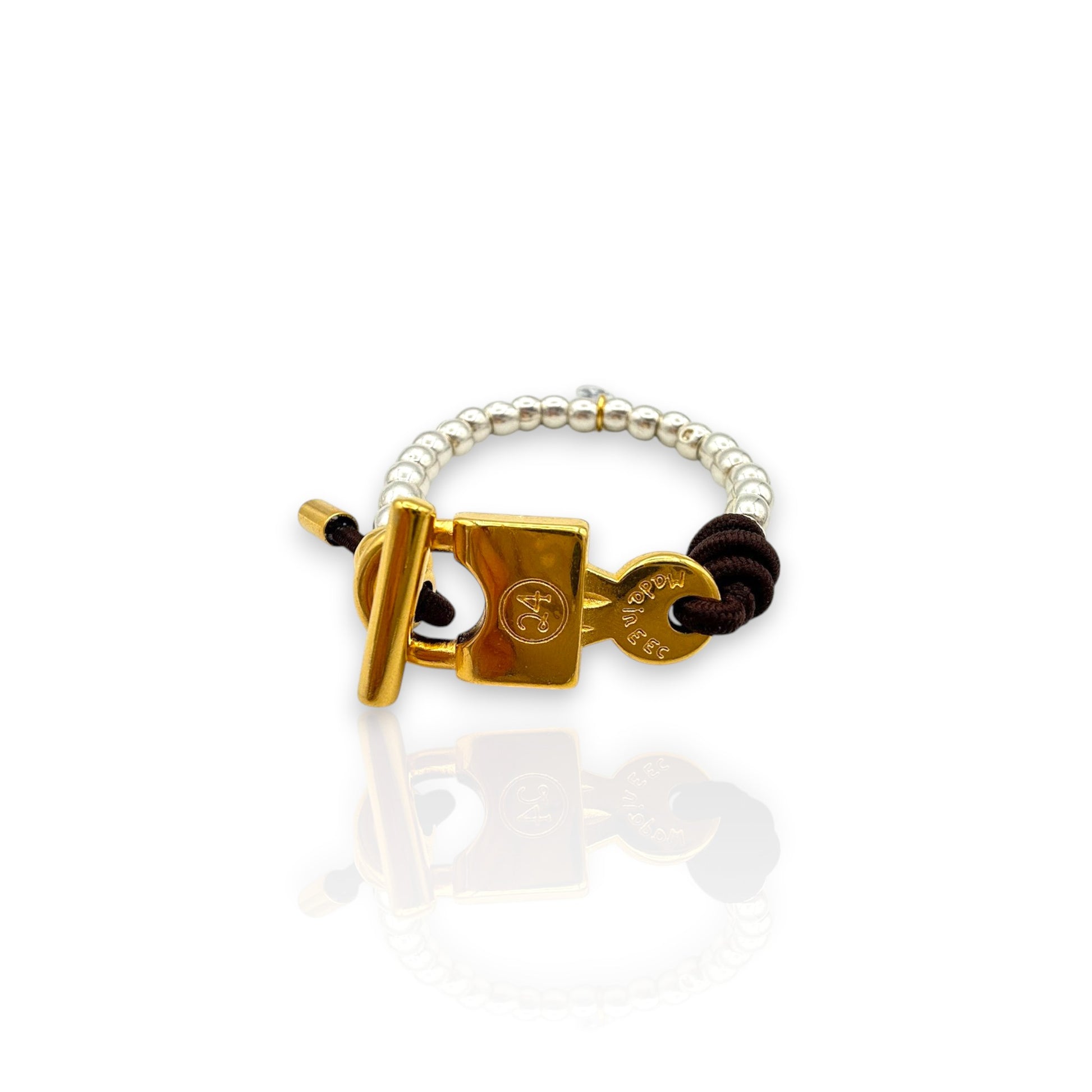 Pulsera Elastica en plata y oro con cierre de candado y elástico marrón, de la marca Maldita Rita