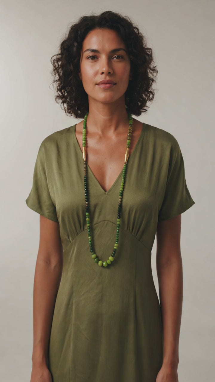Collar en diferentes verdes, cristal checo y piezas con baño de oro. Diseño de Maldita Rita. Visto en una modelo en movimiento
